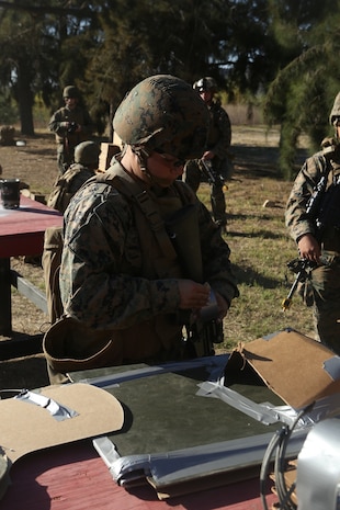 U.S. Marine Lance Cpl. Heather Schneider sets up a body charge in preparation for urban breaching training at Camp Pendleton, Calif., Nov. 17, 2016. Schneider is a combat engineer with Bravo Company, 7th Engineer Support Battalion, 1st Marine Logistics Group.  The Marines with 7th ESB were put into fire teams and tasked to build explosive devices such as a hinge charges, water charges and body charges to forcefully open a locked door. (U.S. Marine Corps Photo by Lance Cpl. Joseph Sorci)