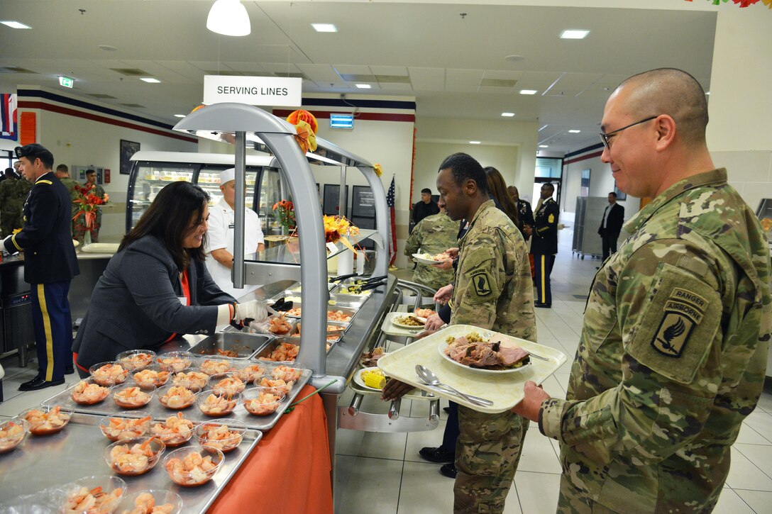 Assistant Secretary of the Army for Manpower and Reserve Affairs Debra S. Wada serves lunch to paratroopers from the 173rd Airborne Brigade during the Thanksgiving lunch celebration at Caserma Del Din in Vicenza, Italy, Nov. 22, 2016. Army photo by Paolo Bovo