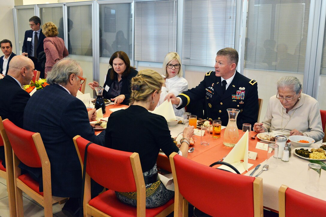 Army Maj. Gen. Joseph P. Harrington, commanding general of U.S. Army Africa, eats lunch with host-nation dignitaries and soldiers during the Thanksgiving lunch celebration at Caserma Del Din in Vicenza, Italy, Nov. 22, 2016. Army photo by Paolo Bovo