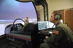 Capt. Mike, left, 558th Flying Training Squadron student, trains on a T-6 simulator, while Capt. Brandt, 558th FTS instructor, operates the instrument computer panel Nov. 7, at Joint Base San Antonio-Randolph.  The 558th FTS is the home of the Air Force's only undergraduate remotely piloted aircraft training program. 