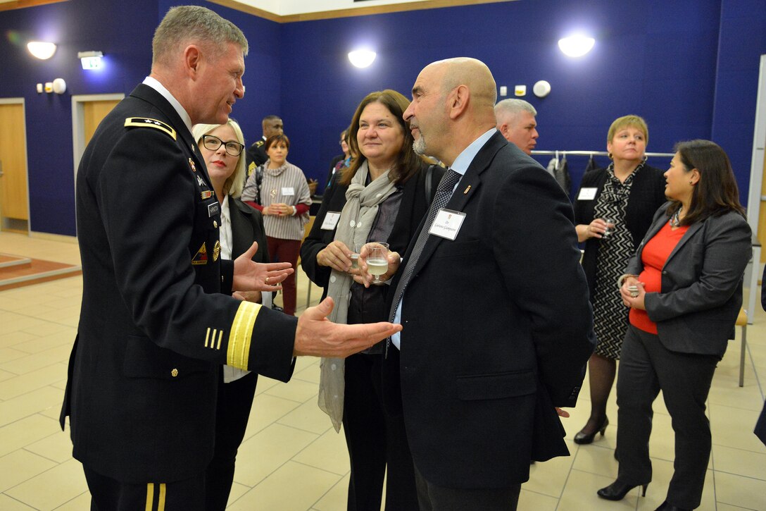 Army Maj. Gen. Joseph P. Harrington, commanding general of U.S. Army Africa, speaks with Dr. Gaetano Giampietro, chief of Vicenza police, during the Thanksgiving lunch celebration at Caserma Del Din in Vicenza, Italy, Nov. 22, 2016. Army photo by Paolo Bovo