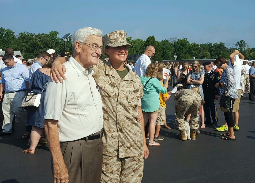 Second Lieutenant Carrie Yonge poses with her grandfather after graduating Officer Candidate School, Aug. 6, 2016. Carrie Yonge’s grandfather, a former Naval aviator, pinned her rank on during the commissioning ceremony after graduating. Yonge is a plans officer with Plans and Research for Marine Corps Recruiting Command.