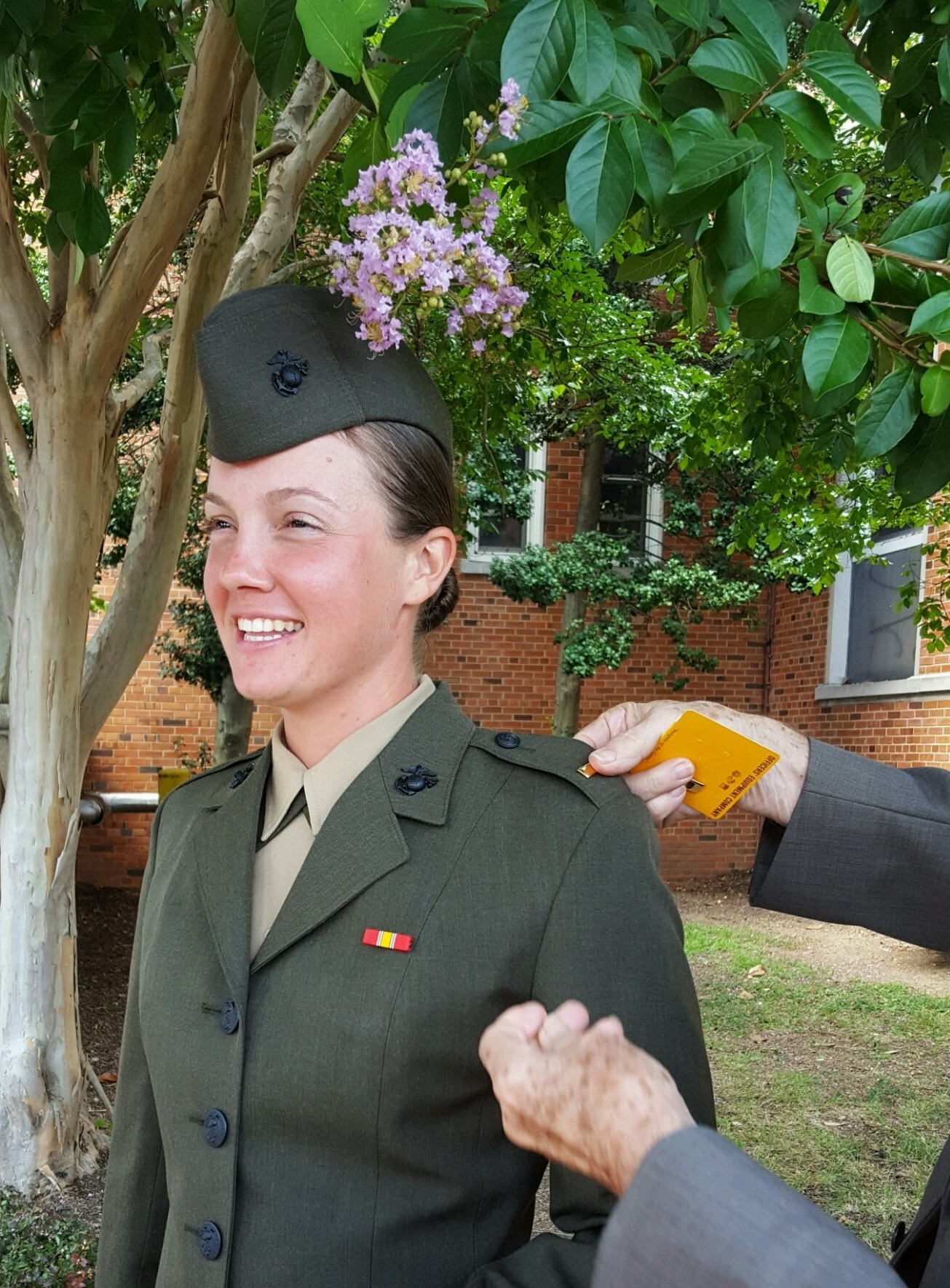 Second Lieutenant Carrie Yonge has her rank pinned onto her uniform by her grandfather, a former Naval aviator, after graduating Officer Candidate School, Aug. 6, 2016. From being cured of poor eyesight to facing financial and living arrangement uncertainty, Yonge conquered several obstacles in her life to earn the title Marine. Yonge is a plans officer with Plans and Research for Marine Corps Recruiting Command.