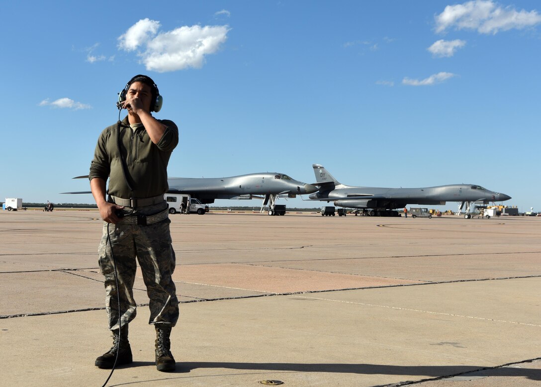 U.S. Air Force Staff Sgt. Kevin Khanthavongsay, 489th Maintenance Squadron B-1B Lancer crew chief, communicates with B-1 pilots at Dyess Air Force Base, Texas, Nov. 22, 2016. The 489th MXS Airmen maintained 100 percent of their sorties with no maintenance issues for 13 straight months. (U.S. Air Force photo by Senior Airman Kedesha Pennant)

