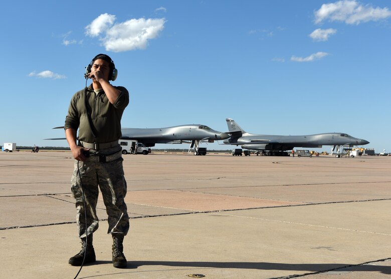 U.S. Air Force Staff Sgt. Kevin Khanthavongsay, 489th Maintenance Squadron B-1B Lancer crew chief, communicates with B-1 pilots at Dyess Air Force Base, Texas, Nov. 22, 2016. The 489th MXS Airmen maintained 100 percent of their sorties with no maintenance issues for 13 straight months. (U.S. Air Force photo by Senior Airman Kedesha Pennant)

