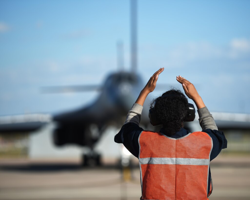 U.S. Air Force Airman Jana Johnson, 7th Aircraft Maintenance Squadron B-1B Lancer crew chief, marshals a B-1 at Dyess Air Force Base, Texas, Nov. 22, 2016. With help from active-duty Airmen, the 489th Maintenance Squadron maintained 100% of B-1 sorties with no maintenance issues. As a part of Total Force Integration, Airmen assigned to the 7th AMXS and the 489th MXS work together to keep bombers flying. (U.S. Air Force photo by Senior Airman Kedesha Pennant)