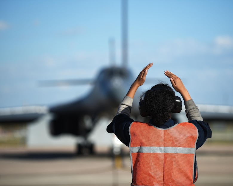 U.S. Air Force Airman Jana Johnson, 7th Aircraft Maintenance Squadron B-1B Lancer crew chief, marshals a B-1 at Dyess Air Force Base, Texas, Nov. 22, 2016. With help from active-duty Airmen, the 489th Maintenance Squadron maintained 100% of B-1 sorties with no maintenance issues. As a part of Total Force Integration, Airmen assigned to the 7th AMXS and the 489th MXS work together to keep bombers flying. (U.S. Air Force photo by Senior Airman Kedesha Pennant)