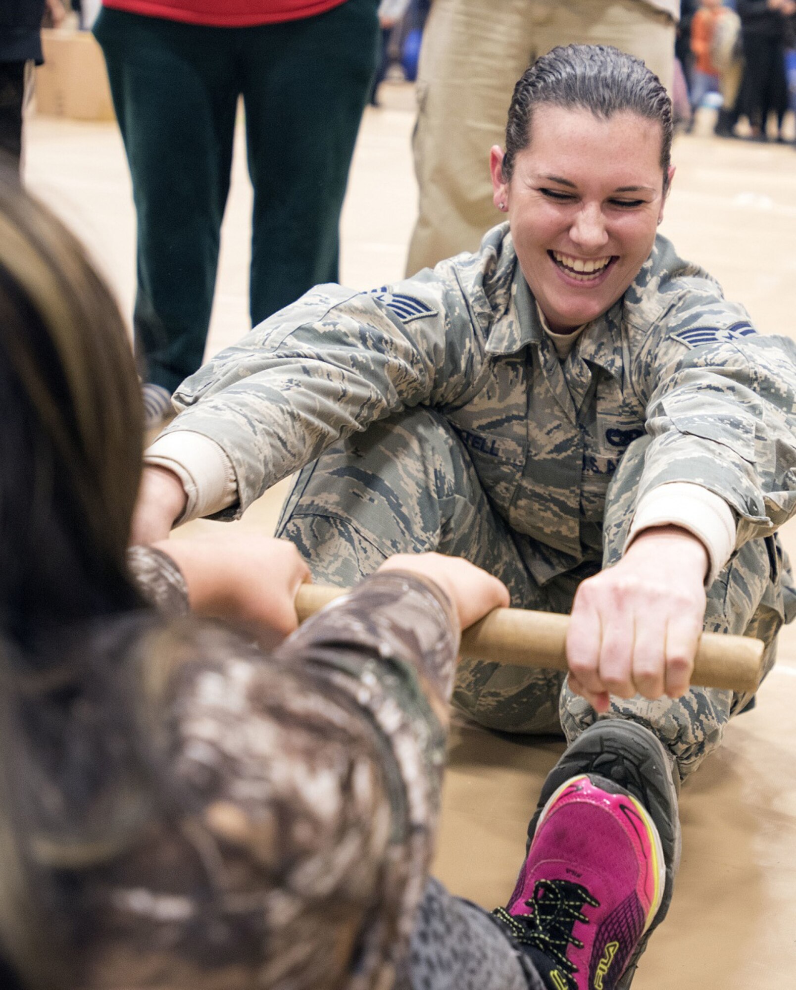 TOGIAK, Alaska -- Staff Sgt. Katelyn Martell, with the Air Force Reserve's 55th Aerial Port Squadron, competes in an "Eskimo stick" contest with a schoolgirl Nov. 15, 2016. Martell was one of a handful of reservists who traveled from Travis Air Force Base, Calif., to assist with Operation Santa Claus 2016. Now in its 60th year, Operation Santa Claus is an Alaska National Guard-led program that delivers toys, school supplies and other gifts to children in Alaska's remote villages. (U.S. Air National Guard photo by Maj. John Callahan/released)
