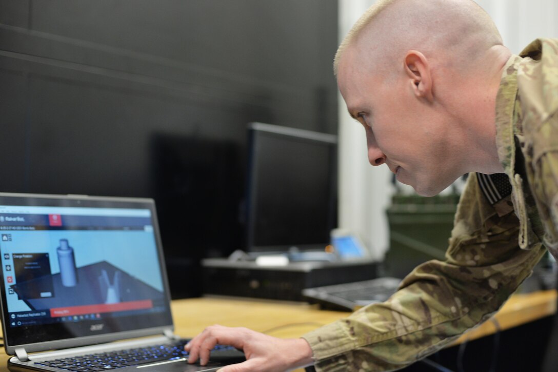 Capt. Daniel Blomberg, 341st Civil Engineer Squadron explosive ordnance disposal flight commander, configures a 3-D working schematic for the printer Nov. 21, 2016, at Malmstrom Air Force Base, Mont. The EOD team is now using a 3-D printer to produce training aids that allow for realistic training without having to preserve them for future training. The training aids can now be made at a low cost, allowing more practical training and saving the unit hundreds to thousands of dollars each year. (U.S. Air Force photo/Airman 1st Class Daniel Brosam)