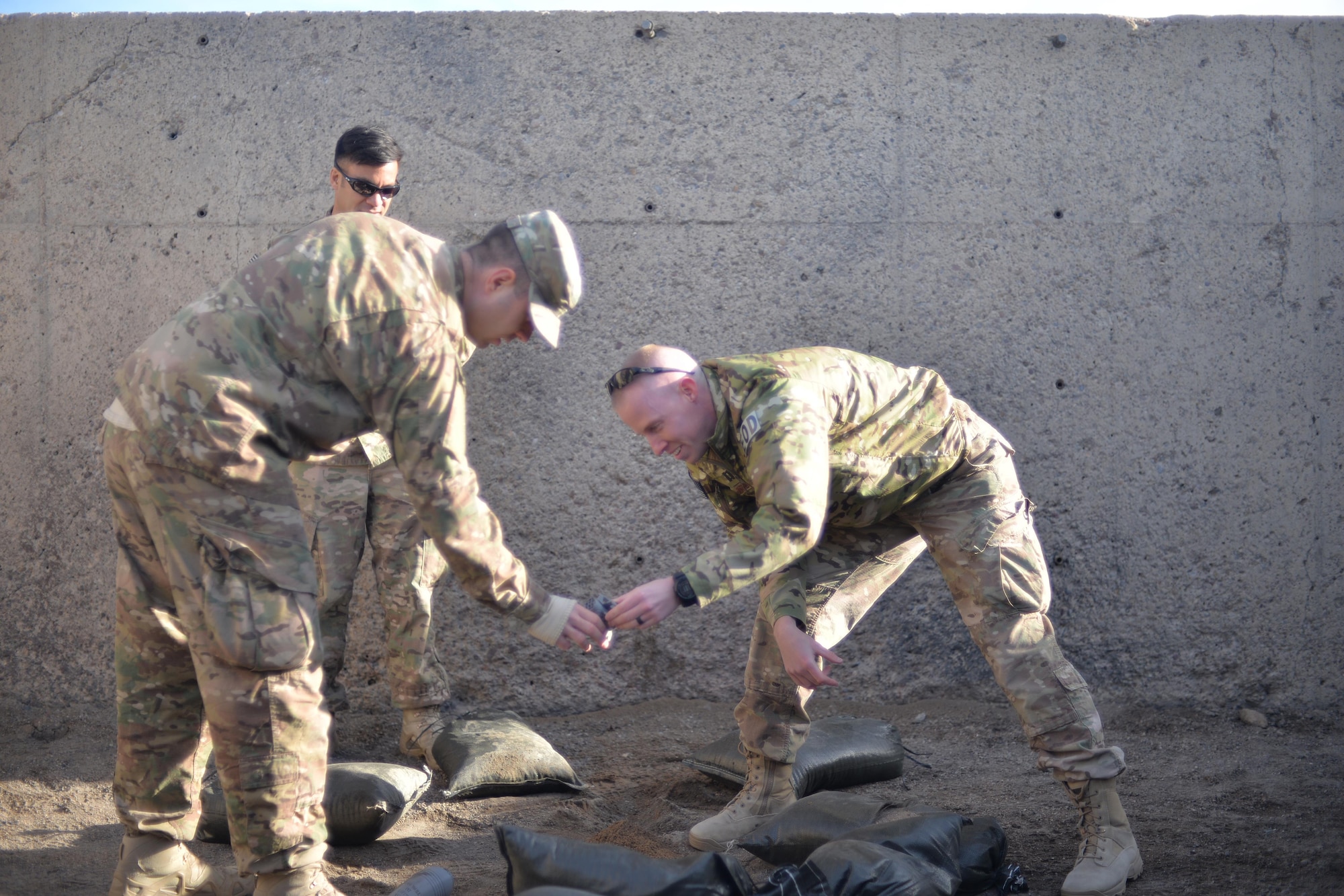 Staff Sgt. Randolph Shandler, 341st Civil Engineer Squadron explosive ordnance disposal team leader, left, stands by as Tech. Sgt. Paul Willson, 341st CES EOD NCO in charge of quality assurance, center left, and Capt. Daniel Blomberg, 341st CES EOD flight commander, inspect a 3-D printed mortar after a render safe training procedure was conducted Nov. 21, 2016, at Malmstrom Air Force Base, Mont. The EOD team is now using a 3-D printer to produce training aids that allow for realistic training without having to preserve them for future training. The training aids can now be made at a low cost, allowing more practical training and saving the unit hundreds to thousands of dollars each year. (U.S. Air Force photo/Airman 1st Class Daniel Brosam)