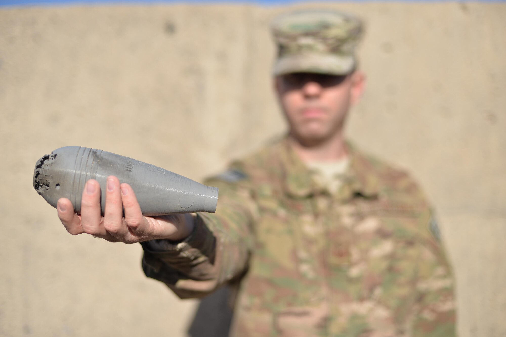 Tech. Sgt. Paul Willson, 341st Civil Engineer Squadron explosive ordnance disposal NCO in charge of quality assurance, holds a 3-D printed mortar after a render safe training procedure was conducted Nov. 21, 2016, at Malmstrom Air Force Base, Mont. The EOD team is now using a 3-D printer to produce training aids that allow for realistic training without having to preserve them for future training. The training aids can now be made at a low cost, allowing more practical training and saving the unit hundreds to thousands of dollars each year. (U.S. Air Force photo/Airman 1st Class Daniel Brosam)