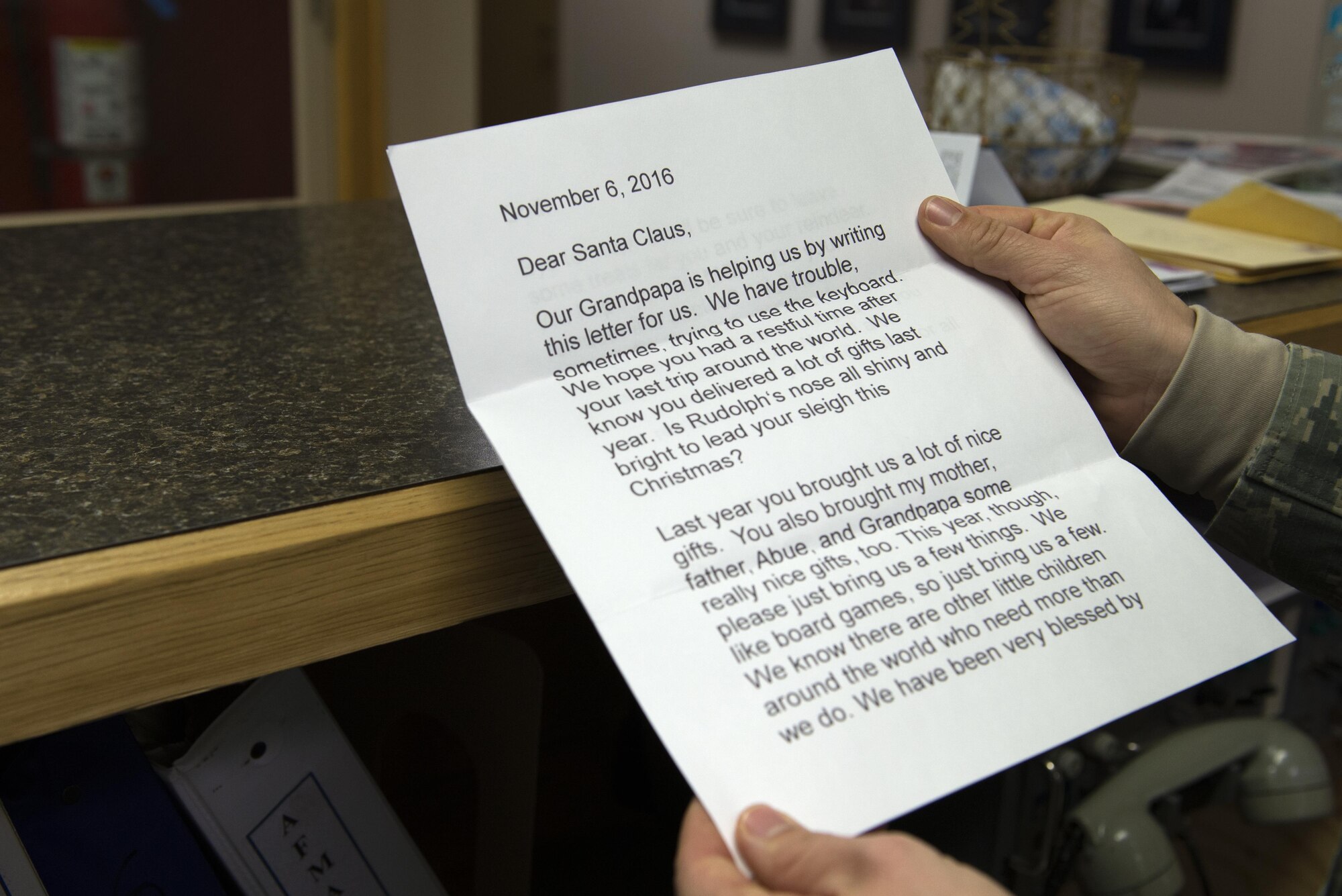 U.S. Air Force Airman 1st Class Lisa Rogers, a 354th Operations Support Squadron weather forecaster apprentice, holds a letter to Santa, Nov. 22, 2016, at Eielson Air Force Base, Alaska. Letters come from all over the world and the weather flight acts as Santa’s elves, sending letters back to children. (U.S. Air Force photo by Airman 1st Class Cassandra Whitman)