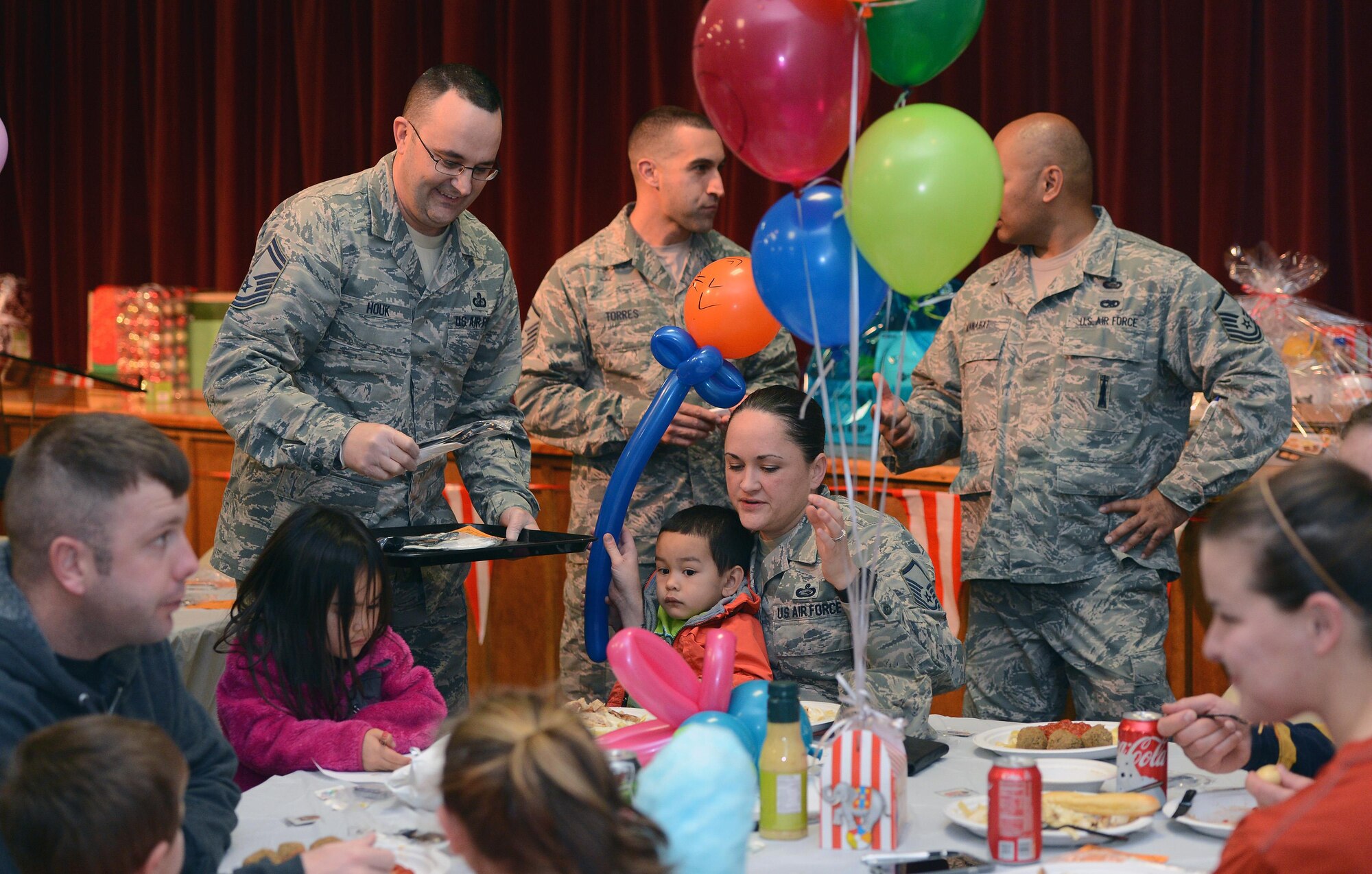 Senior Master Sgt. Jess Houk (left), 62nd Comptroller Squadron superintendent, serves food to Airmen and their families during the Hearts Apart dinner Nov. 17, 2016, at Joint Base Lewis-McChord, Wash. The dinner was attended by more than 50 Airmen and their families, who were provided a catered meal. (U.S. Air Force photo/Senior Airman Jacob Jimenez) 