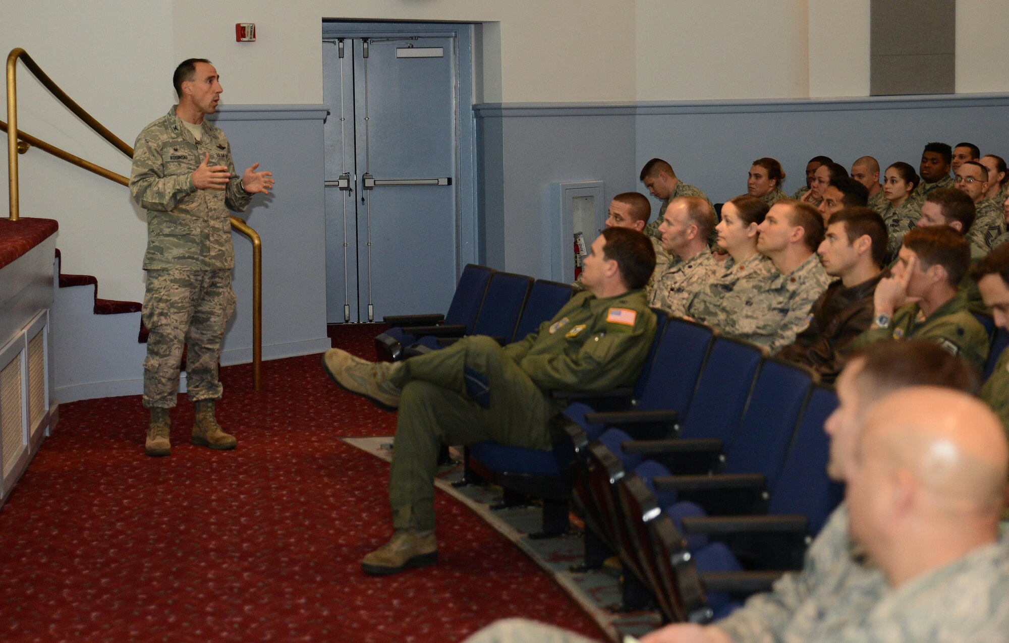Col. Leonard Kosinski, 62nd Airlift Wing commander, speaks to Team McChord Airmen about mission priorities during a commander’s call Nov. 22, 2016, at Joint Base Lewis-McChord, Wash. Kosinski hosted a question and answer session utilizing a phone application that allowed Airmen to text in their questions and receive immediate answers. (U.S. Air Force photo/Senior Airman Jacob Jimenez)   