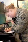 Airman 1st Class McKenzie Wolaver, 5th Bomb Wing command post emergency action officer, receives a phone call at Minot Air Force Base, N.D., Nov. 15, 2016. The command post is the central node for receiving and disseminating information to multiple organizations. They provide the most up-to-date information to wing leadership, allowing for deliberate mission execution. (U.S. Air Force photo/Airman 1st Class Jessica Weissman)