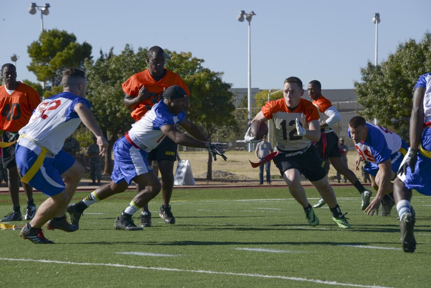 Members of the Davis-Monthan Air Force Base Mustangs close in on an offensive member of the Fort Huachuca Black Knights during the 3rd annual Army vs. Air Force Turkey Bowl at Fort Huachuca, Ariz., Nov. 18, 2016. The D-M Mustangs took home their third straight victory with a 14-13 win over the Black Knights. (U.S. Air Force photo by Senior Airman Betty R. Chevalier)