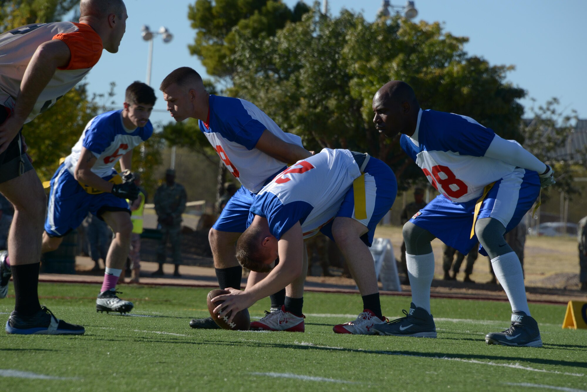 Offensive members of the Davis-Monthan Air Force Base Mustangs prepare to snap the ball during the 3rd annual Army vs. Air Force Turkey Bowl at Fort Huachuca, Ariz., Nov. 18, 2016. Fort Huachuca hosted the flag football game to promote camaraderie, build esprit de corps, and collect food for the community food bank. (U.S. Air Force photo by Senior Airman Betty R. Chevalier)