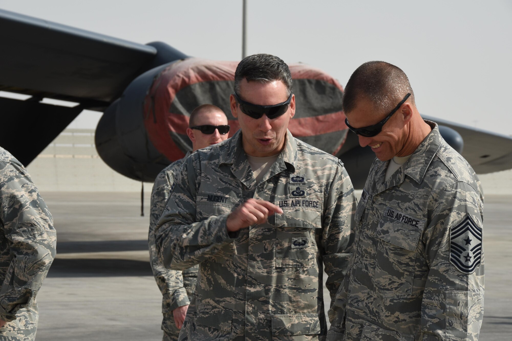 Chief Master Sgt. Steve McDonald, Air Combat Command command chief master sergeant, reunites with a wingman, Chief Master Sgt. Matthew Nugent, superintendent of the 379th Expeditionary Operations Group, Nov. 23, 2016, during a tour of the 379th Air Expeditionary Wing, at Al Udeid Air Base, Qatar. (U.S. Air Force photo by Senior Airman Cynthia A. Innocenti)