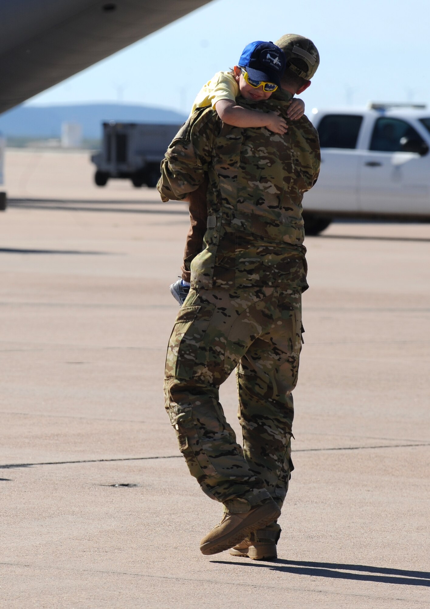 Jonathan Tupta clings to his father, Capt. Shawn Tupta, 39th Airlift squadron pilot, at Dyess Air Force Base, Texas, Nov. 21, 2016. Tupta, along with 15 other Airmen, deployed for four months supporting Horn of Africa operations and missions for the U.S. European Command.  (U.S. Air Force photo by Airman 1st Class Emily Copeland)