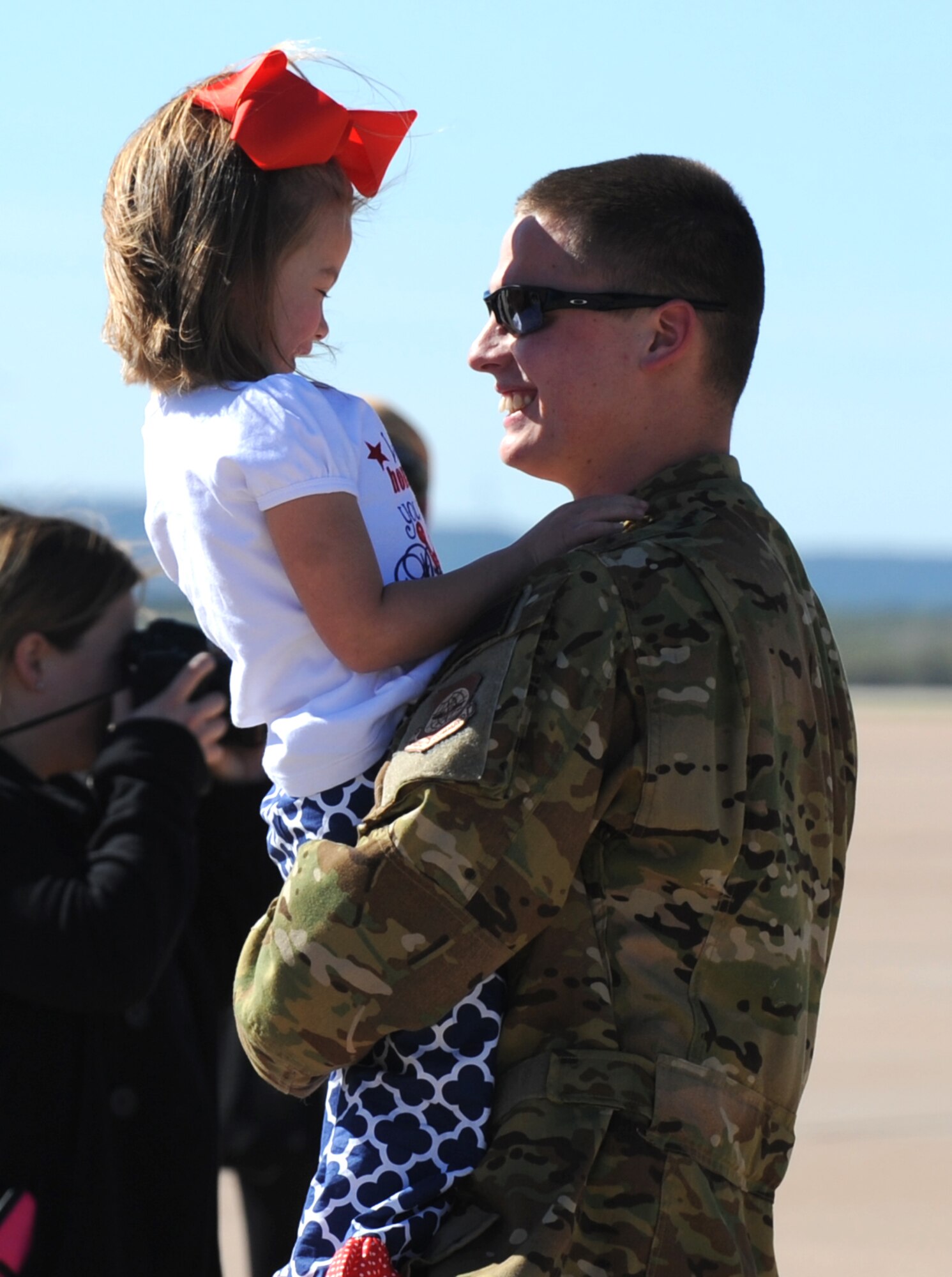 U.S. Air Force Senior Airman Nicholas McGuire, 40th Airlift squadron loadmaster, shares a smile with his daughter, Adalee McGuire, upon returning from a four month deployment at Dyess Air Force Base, Texas, Nov. 21, 2016. Dyess aircrew have a rotational deployment schedule, which provides combat-delivery capabilities through tactical airlift and airdrop operations as well as humanitarian efforts. (U.S. Air Force photo by Airman 1st Class Emily Copeland)