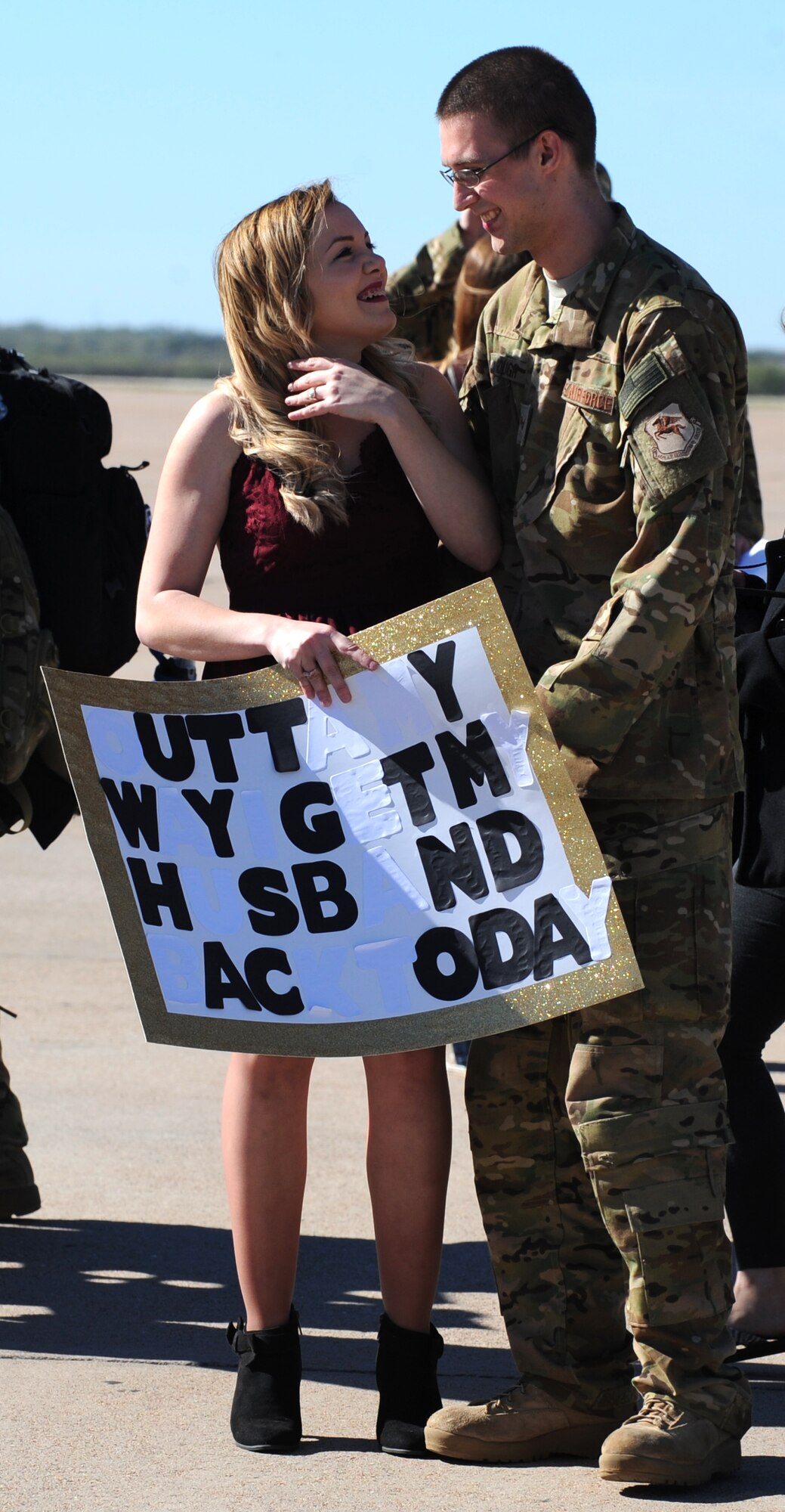 Makali Gough is greeted by her husband, Senior Airman Jared Gough, 40th Airlift Squadron loadmaster, at Dyess Air Force Base, Texas, Nov. 21, 2016. Two C-130Js and 16 aircrew members returned from a four month deployment to Germany and Africa, where the aircrew conducted missions supporting Horn of Africa operations by landing at small landing zones and conducting airdrops in eastern Africa. They also flew numerous missions over Europe to supplement EUCOM’s airlift assets. (U.S. Air Force photo by Airman 1st Class Emily Copeland)