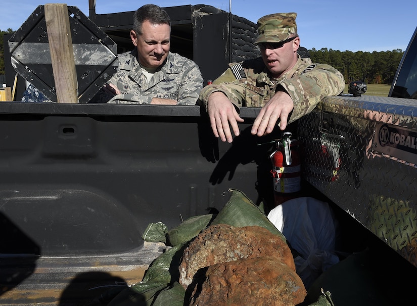 Master Sgt. Tracy Passerotti, 628th Civil Engineer Squadron, right, explosive ordnance disposal technician explains to JB Charleston commander Col. Robert Lyman, left, the background and procedures of proper disposal of Civil War-era explosives here. The 628th CES EOD flight worked with local emergency management teams to safely dispose of explosives brought ashore by the tides of Hurricane Matthew in October. 