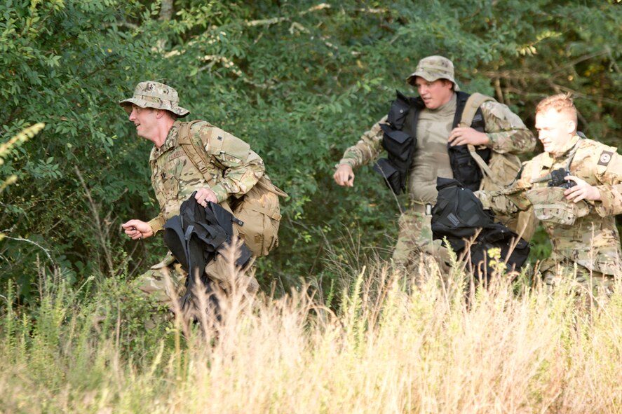 U.S. Air Force Capt. Nick Rapp, a C-130J pilot assigned to the 41st Airlift Squadron, leads a group into the woods after escaping simulated internment during the land navigation portion of survival, evasion, resistance and escape (SERE) training, June 22, 2016, at Little Rock Air Force Base, Ark. SERE specialists from Team Little Rock teach a wide range of survival skills to aircrew members, from building shelters, finding potable water, avoidance techniques and eating insects; all things they will need to know to survive until rescued, should they find themselves down behind enemy lines. (U.S. Air Force photo by Master Sgt. Jeff Walston/Released)