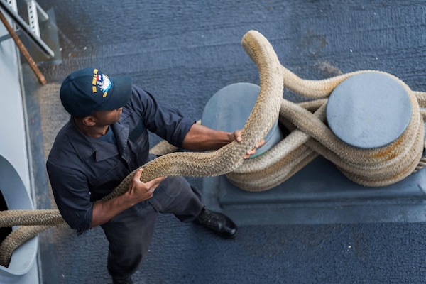 Navy Seaman Willie Cross heaves a line on the fantail of the USS John C. Stennis as the ship gets underway from Naval Base Kitsap - Bremerton, Wash., Nov. 22, 2016. The Stennis is underway to  participate in National Pearl Harbor Remembrance Day events in Hawaii. Navy photo by Seaman Cole C. Pielop
