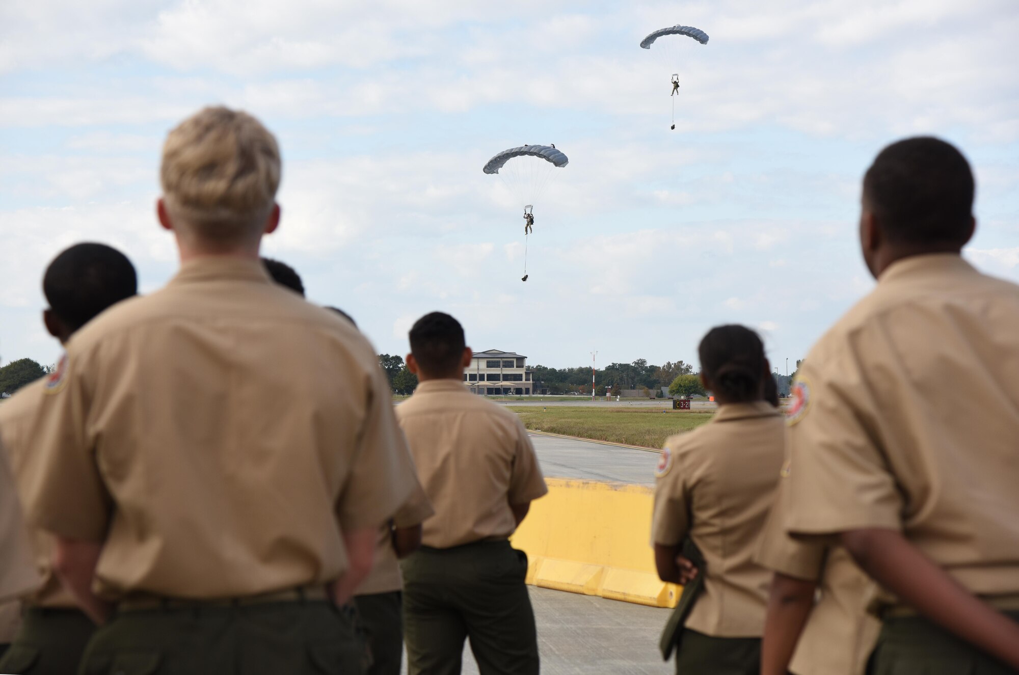 Mississippi sigh school Junior ROTC drill teams watch 334th Training Squadron battlefield Airmen conduct a parachute demonstration during the Third Annual Mississippi All-Services Junior ROTC Drill Competition Nov. 18, 2016, on Keesler Air Force Base, Miss. More than 500 Junior ROTC cadets, spectators and volunteers were in attendance where cadets battled for the best all-services Junior ROTC team in Mississippi. Seventeen Junior ROTC teams from all military branches were represented at the event with the Biloxi High School Air Force Junior ROTC earning the top honors. (U.S. Air Force photo by Kemberly Groue)