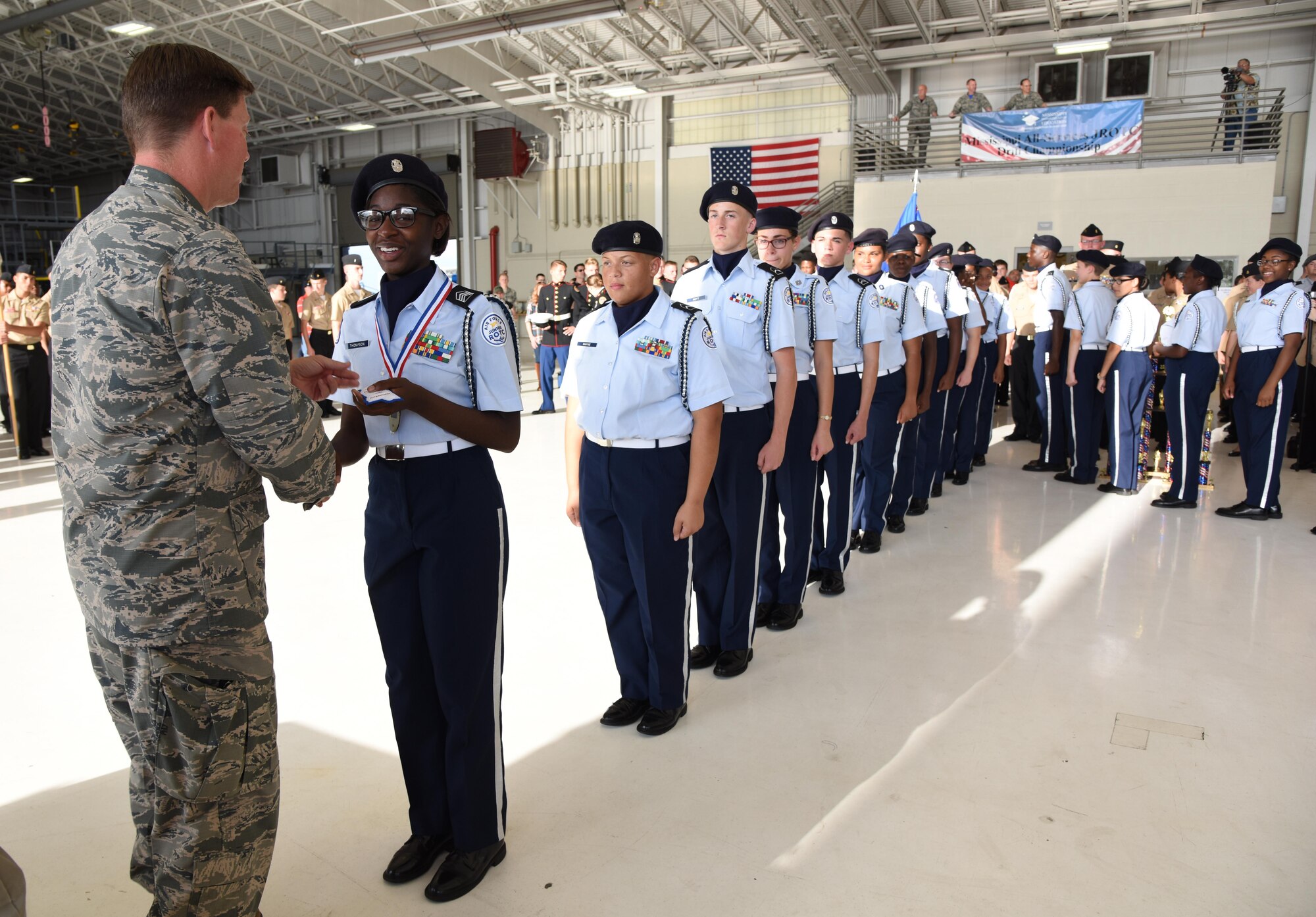 Col. C. Mike Smith, 81st Training Wing vice commander, presents medals and patches to Biloxi High School Air Force Junior ROTC, Biloxi, Miss., members for earning top honors during the Third Annual Mississippi All-Services Junior ROTC Drill Competition Nov. 18, 2016, on Keesler Air Force Base, Miss. More than 500 Junior ROTC cadets, spectators and volunteers were in attendance where cadets battled for the best all-services Junior ROTC team in Mississippi. Seventeen Junior ROTC teams from all military branches were represented at the event with the Biloxi High School Air Force Junior ROTC earning the top honors. (U.S. Air Force photo by Kemberly Groue)