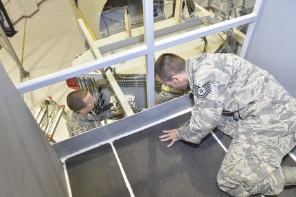 U.S. Air Force Tech. Sgt. Nathon Horrocks, 373rd Training Squadron Detachment 5 flight controls training instructor, teaches proper flight control maintenance to an Airman Nov. 22, 2016, at Joint Base Charleston, South Carolina. 373rd TRS Det. 5 has 11 Maintenance Training Devices (MTDs) on site. MTDs are sections of the C-17 for the students to train in a safe and controlled setting while developing their technical skills. The hands-on training helps familiarize students with the aircraft and its key parts.