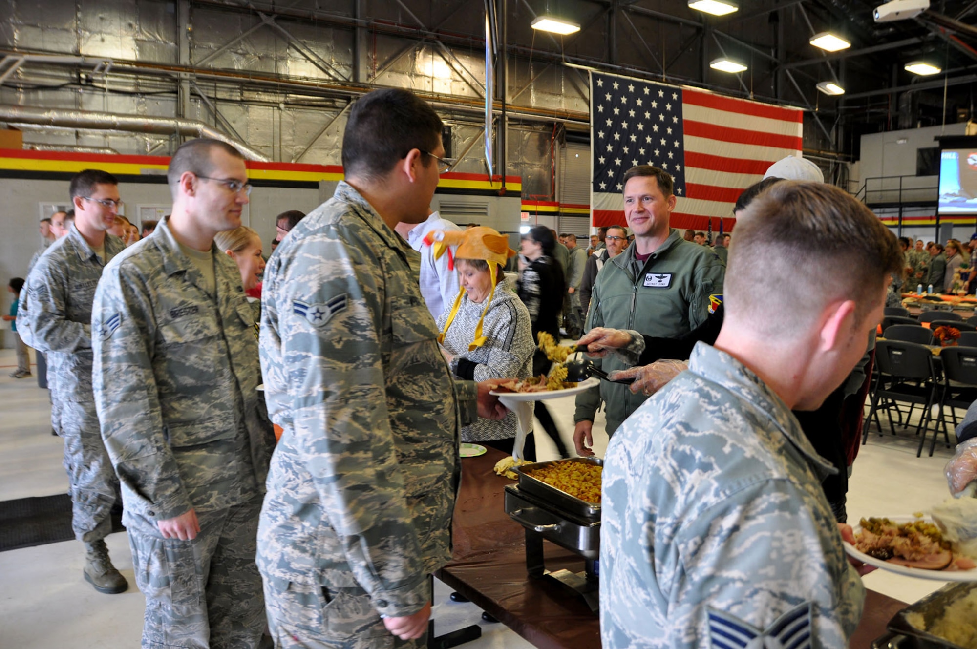 Col. David Lyons, 388th Fighter Wing commander, helps serve food to Airmen and their families during a Thanksgiving feast at Hill Air Force Base Nov. 23.
