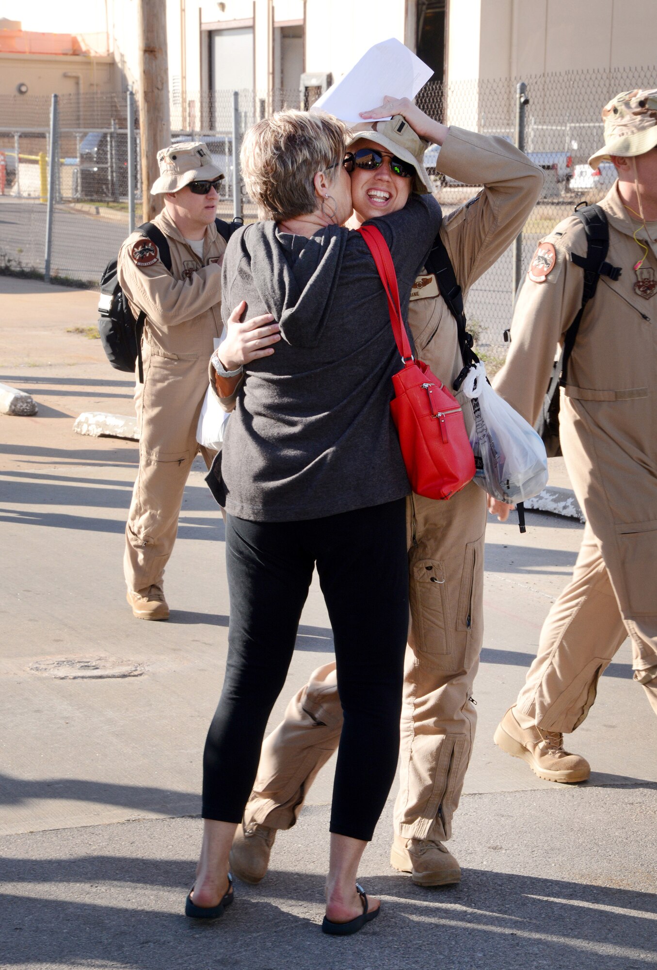First Lt. Stephanie’s mom, Grace, runs to embrace her daughter after the lieutenant’s arrival from her deployment with her squadron. (Air Force photo by Kelly White)
