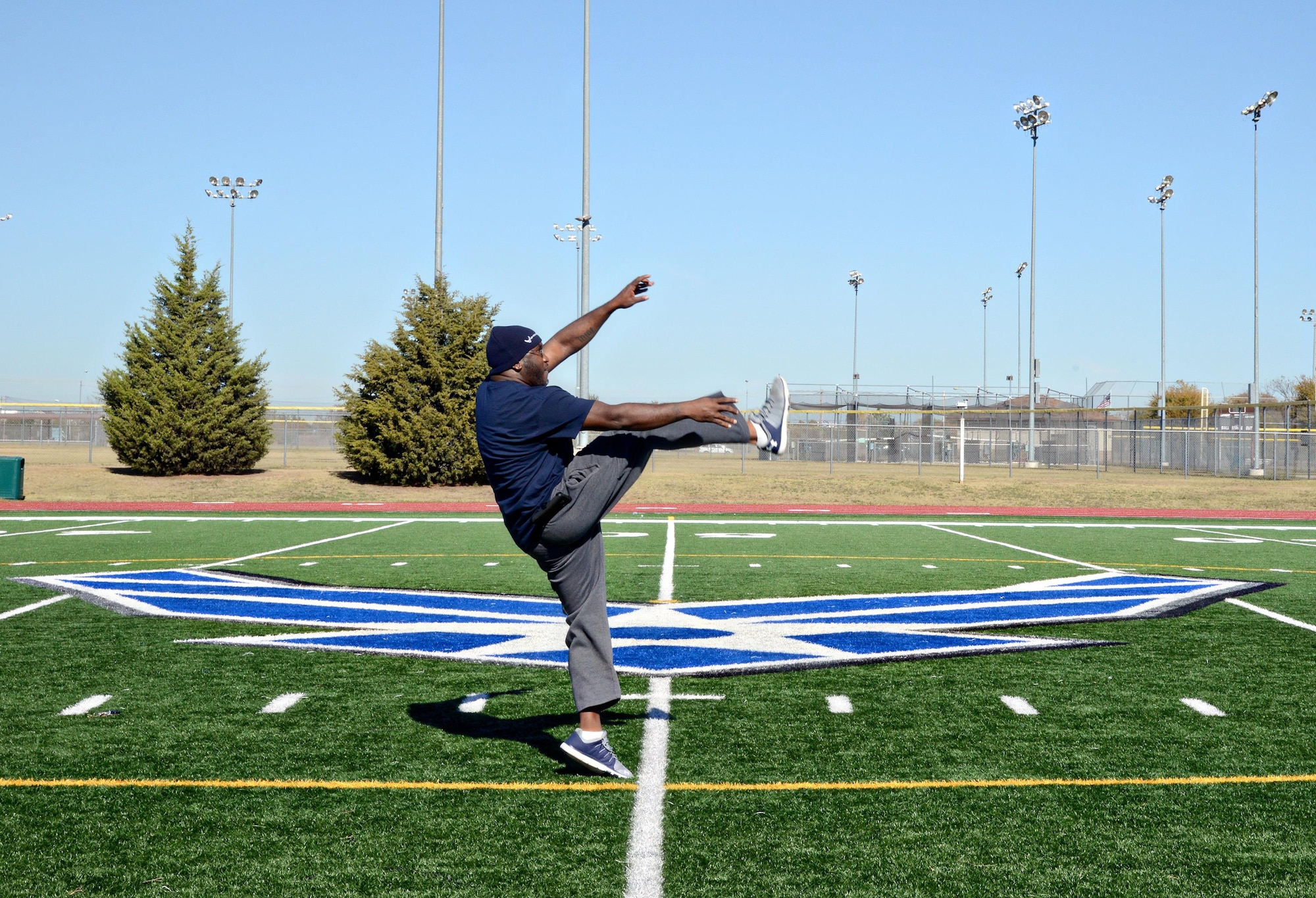 Marcus Baucom, with the Fit Assessment Cell (FAC), shows participants how far they need to kick the football for the longest kick contest in the Great American Smokeout Kickoff event Nov. 16. Health Promotions partnered with the Gerrity Gym at the Tinker football field and track to bring awareness and fun to the event with the longest throw and the longest kick contest to encourage tobacco users to “go the distance and kick the habit!” The winner of the longest kick was Brett Kearney and the winner of the longest throw was Capt. Zach Fleming. Health Promotions had a table filled with tobacco cessation kits and other valuable information. (Air Force photo by Kelly White)