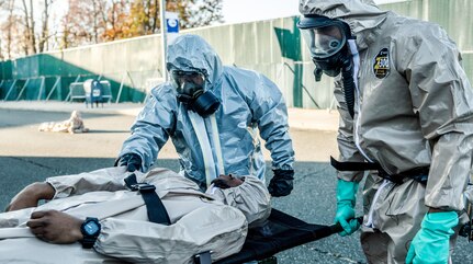 A New York Army National Guard Soldier of the 222nd Chemical Company, based at Fort Hamilton, Brooklyn, right conducts a simulated de-contamination with a member of the  New York Police Department's Chemical Ordnance, Biological and Radiological Awareness (COBRA) unit at Rodman's Neck Tactical Village in the Bronx, N.Y., on Nov. 19, 2016.