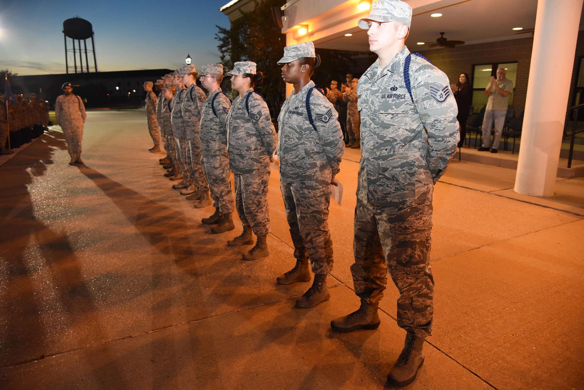 Airmen stand in formation during a Military Training Leader Course graduation ceremony at Keesler Air Force Base, Miss., Nov. 18, 2016. The graduates wear a blue aiguillette to signify their role in the Air Force as a MTL. These Airmen are the first graduates to attend a revised MTL course which includes Human Behavior and the Profession of Arms Center of Excellence training. (U.S. Air Force photo by Kemberly Groue)