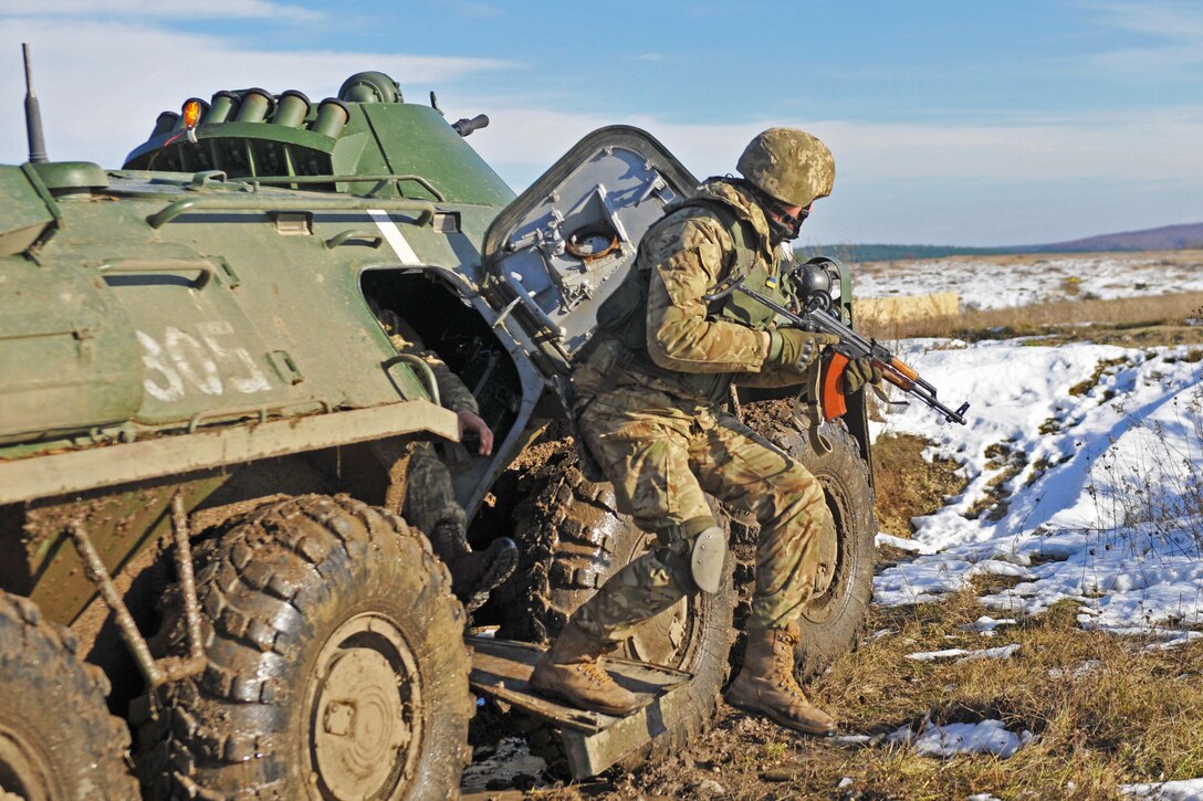 A U.S. soldier jumps from an armored vehicle during suppressive fire training with Ukrainian counterparts in Yavoriv, Ukraine, Nov. 18, 2016.  Army photo by Staff Sgt. Elizabeth Tarr