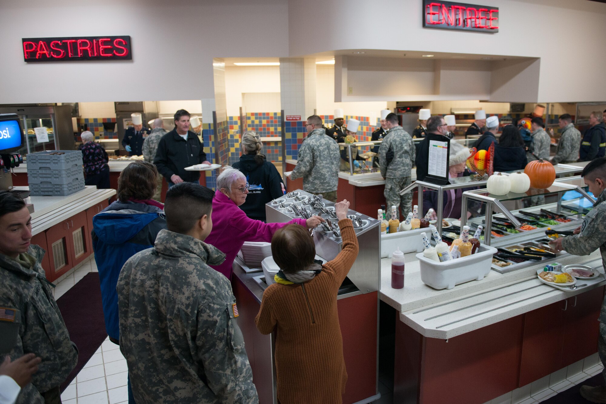 Soldiers, Airmen and civilians fill up the Wilderness Inn Dining Facility on Joint Base Elmendorf-Richardson, Alaska for a thanksgiving meal served by base leadership Nov 23. As a matter of tradition, every year, base leadership serve the Soldiers and Airmen of JBER a thanksgiving meal.