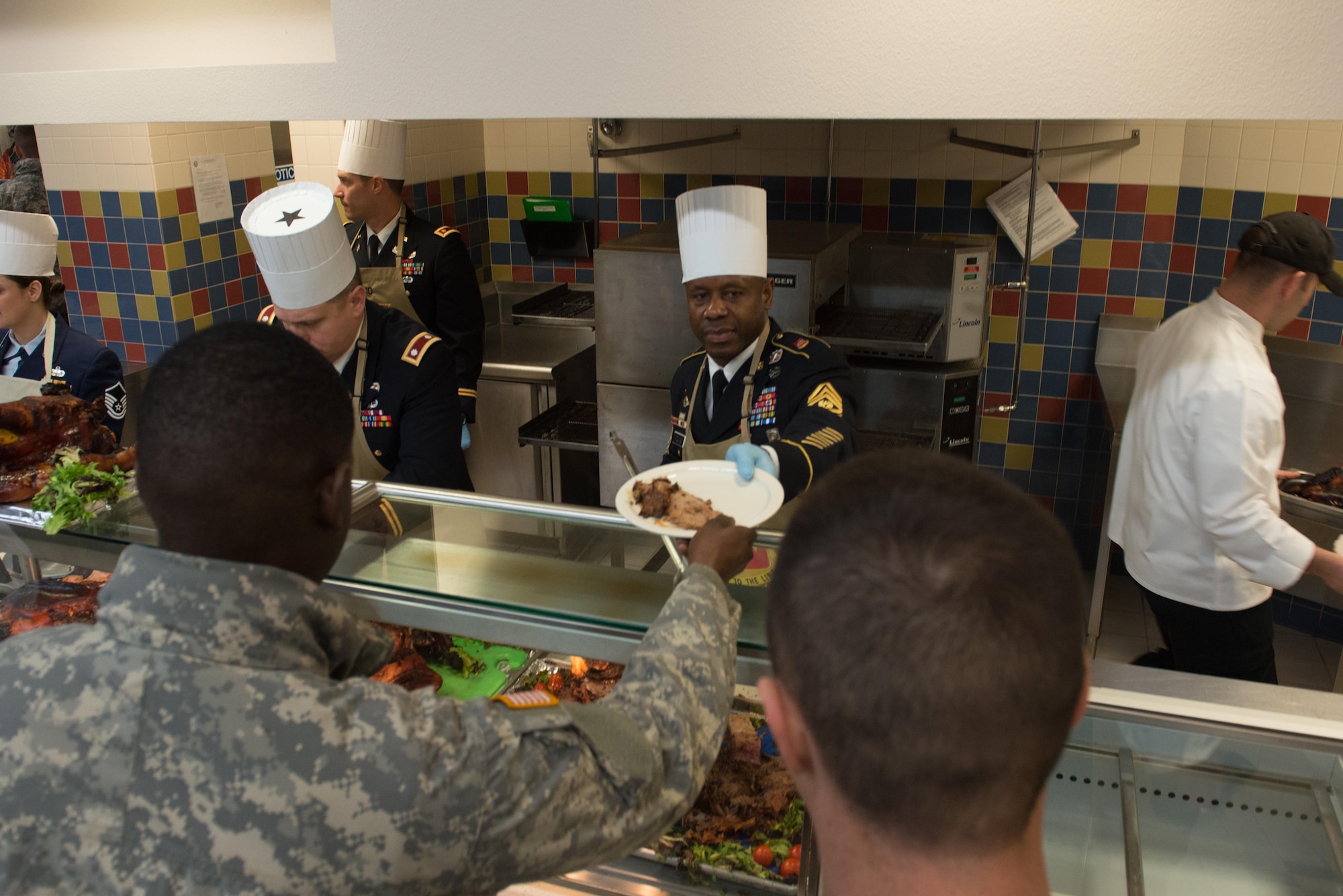 Soldiers, Airmen and civilians fill up the Wilderness Inn Dining Facility on Joint Base Elmendorf-Richardson, Alaska for a thanksgiving meal served by base leadership Nov 23. As a matter of tradition, every year, base leadership serve the Soldiers and Airmen of JBER a thanksgiving meal. 