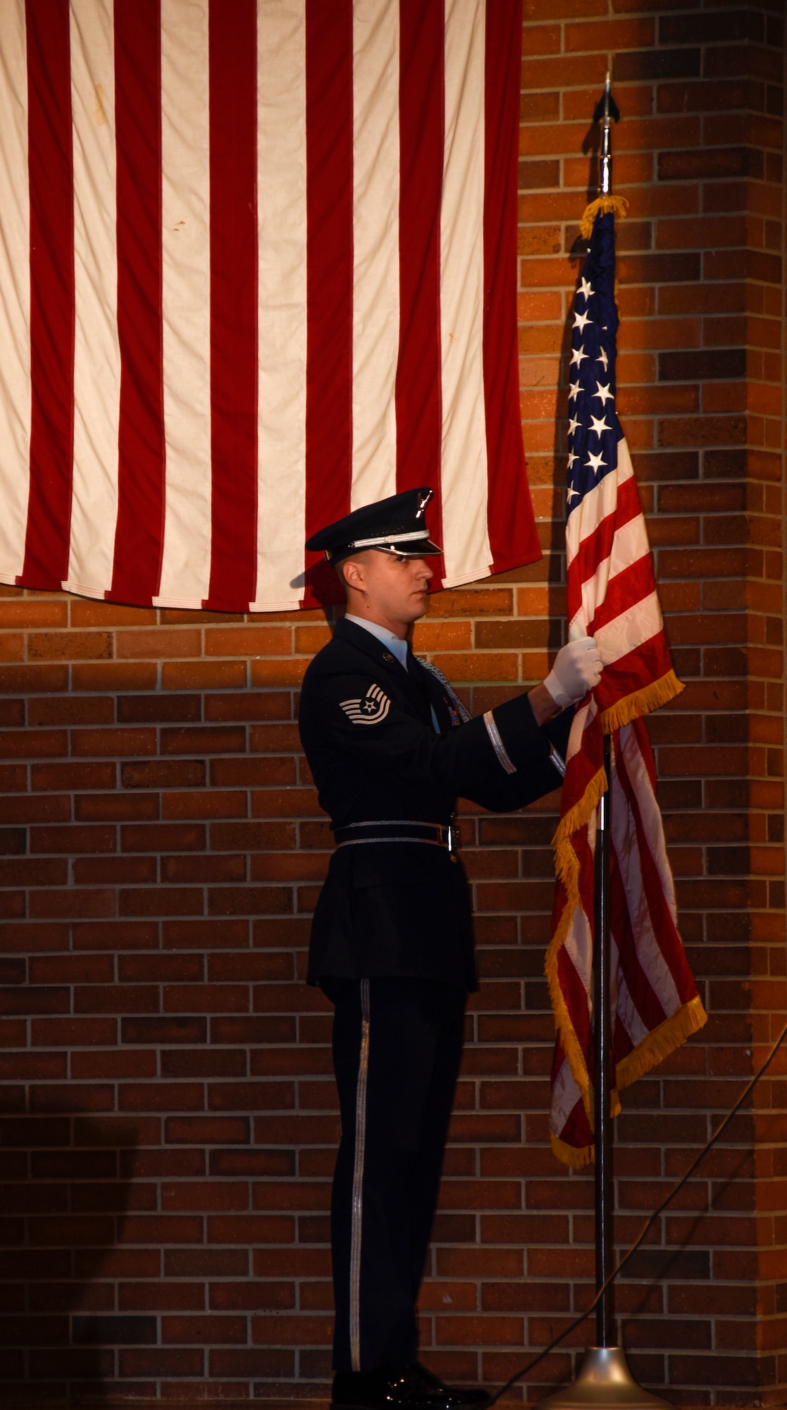 SIOUX FALLS, S.D. - Tech. Sgt. Alex Oppold, 114th Communication Flight cyber security technician, posts the U.S. flag during this years Veteran's Day program at Lincoln High School, Sioux Falls, S.D. The 114th Fighter Wing color guard is organized through the Non-Commissioned Officer Academy Graduates Association where they strive to instill pride and esprit de’ corps through patriotism and community involvement. (U.S. Air Guard photo by Staff Sgt. Duane Duimstra/Released)

