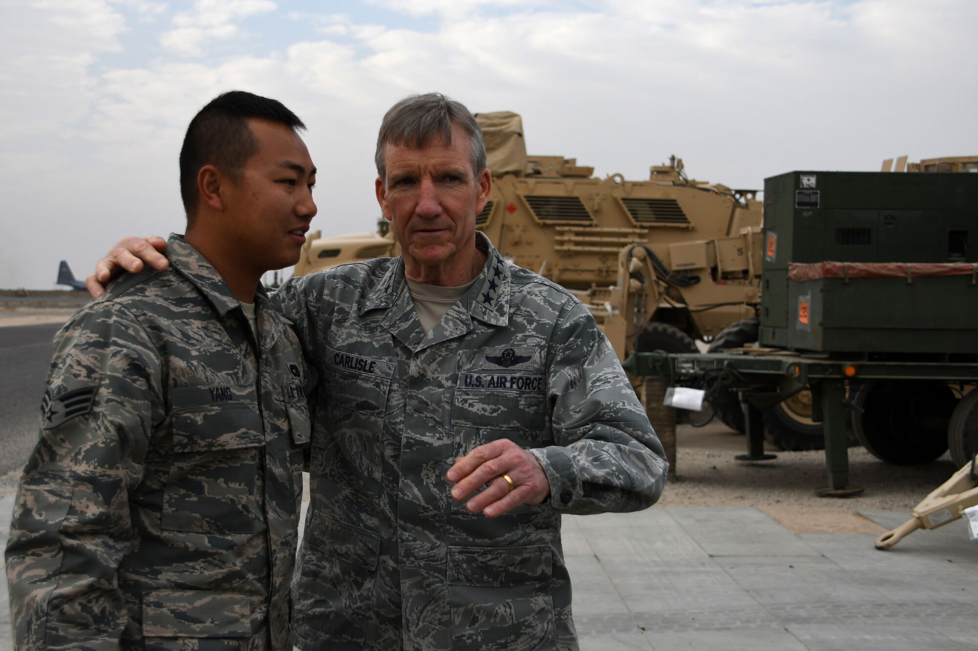 U.S. Air Force Gen. Hawk Carlisle, commander of Air Combat Command, shows his appreciation for Senior Airman Sang Yang, 386th Expeditionary Logistics Readiness Squadron air transportation journeyman, Nov. 23, 2016 at an undisclosed location in Southwest Asia. During his visit, Carlisle personally thanked Airmen across the wing for volunteering to serve their nation thousands of miles away from their families.  (U.S. Air Force photo/Senior Airman Andrew Park)