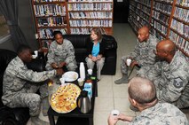 Mrs. Gillian Carlisle, wife of U.S. Air Force Gen. Hawk Carlisle, commander of Air Combat Command, speaks with 386th Expeditionary Force Support Airmen at The Wired morale facility at an undisclosed location in Southwest Asia Nov. 23, 2016. This tour gave Mrs. Carlisle an opportunity to visit various morale, recreation and welfare facilities 386th Air Expeditionary Wing Airmen use on a daily basis. (U.S. Air Force photo/Tech. Sgt. Kenneth McCann)