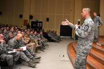 Chief Master Sgt. Steve McDonald, command chief master sergeant of Air Combat Command, left, and U.S. Air Force Gen. Hawk Carlisle, commander of Air Combat Command, right, answer Airmen's questions during an All Call held Nov. 23, 2016 at an undisclosed location in Southwest Asia. McDonald and Carlisle addressed Airmen's concerns regarding subjects ranging from distance learning to enlisted pilot programs. (U.S. Air Force photo/Senior Airman Andrew Park)