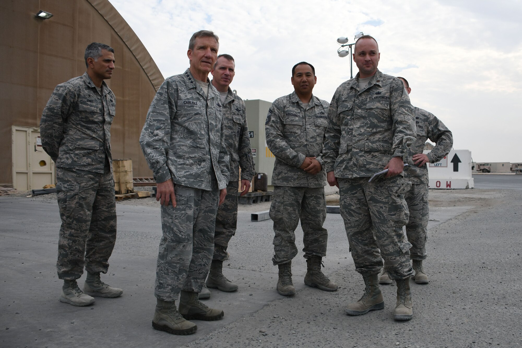 U.S. Air Force Gen. Hawk Carlisle, commander of Air Combat Command, tours the 386th aerial port Nov. 23, 2016 at an undisclosed location in Southwest Asia. Carlisle visited the 386th to gain appreciation for the wing's operations throughout the U.S. Central Command region and to thank Airmen personally for their service during the holiday season. (U.S. Air Force photo/Senior Airman Andrew Park)