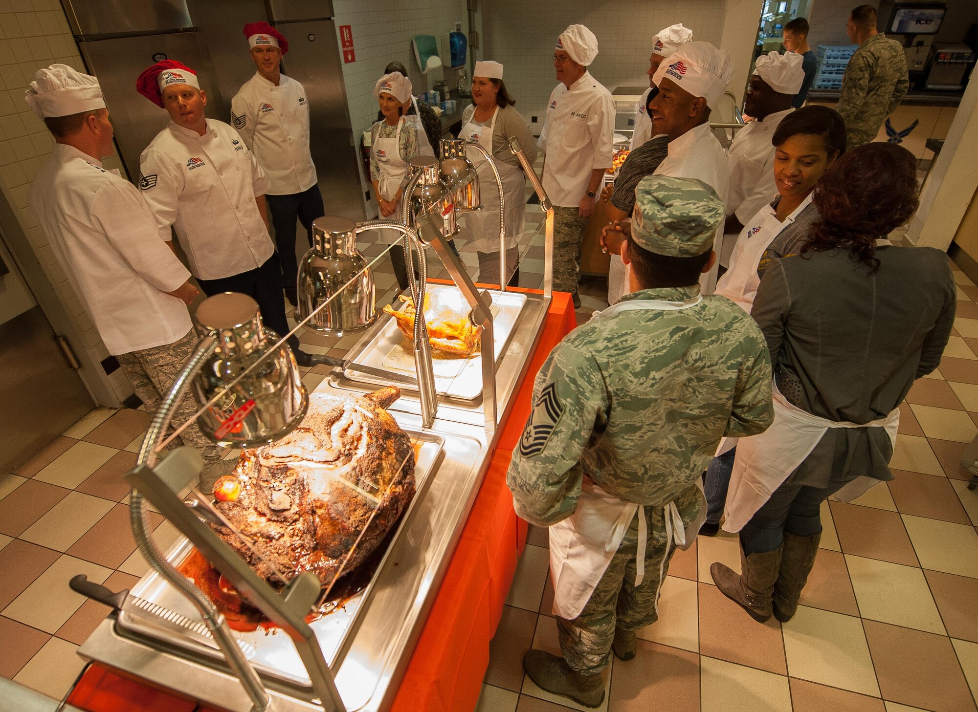 Ramstein leadership meet with the Rheinland Inn Dining Facility staff before Airmen eat during a Thanksgiving meal at Ramstein Air Base, Germany, Nov. 24, 2016. Every year at Ramstein, leadership across the Kaiserslautern Military Community visits the base’s dining facility to cook food and meet Airmen during Thanksgiving. In the U.S., the modern Thanksgiving holiday tradition can trace its origins back to 1621 in the heart of a newly-founded city called Plymouth in present-day Massachusetts. However, the first nationwide Thanksgiving proclamation was made by the first president of the U.S., George Washington, in 1789. Since then, the holiday has been celebrated by an entire nation to recount the blessings of the year. (U.S. Air Force photo by Airman 1st Class Lane T. Plummer)