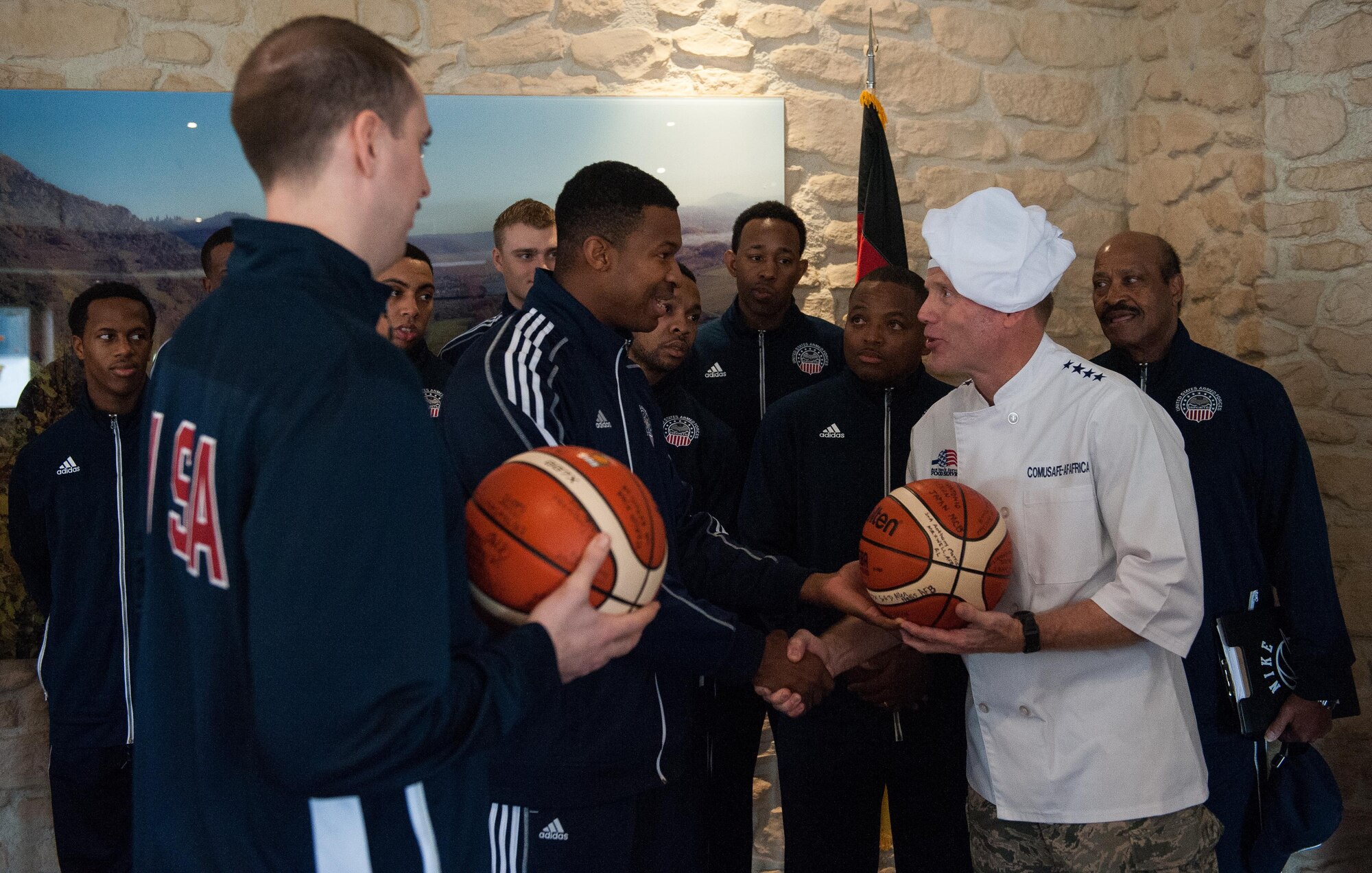 Gen. Tod D. Wolters, U.S. Air Forces in Europe and Air Forces Africa commander, receives an honorary signed basketball from the Armed Forces Basketball Team during a Thanksgiving meal at Ramstein Air Base, Germany, Nov. 24, 2016. Leaders gathered to serve holiday meals to Airmen and their families and to wish everyone a safe and happy holiday. In the U.S., the modern Thanksgiving holiday tradition can trace its origins back to 1621 in the heart of a newly-founded city called Plymouth in present-day Massachusetts. However, the first nationwide Thanksgiving proclamation was made by the first president of the U.S., George Washington, in 1789. Since then, the holiday has been celebrated by an entire nation to recount the blessings of the year. (U.S. Air Force photo by Airman 1st Class Lane T. Plummer)