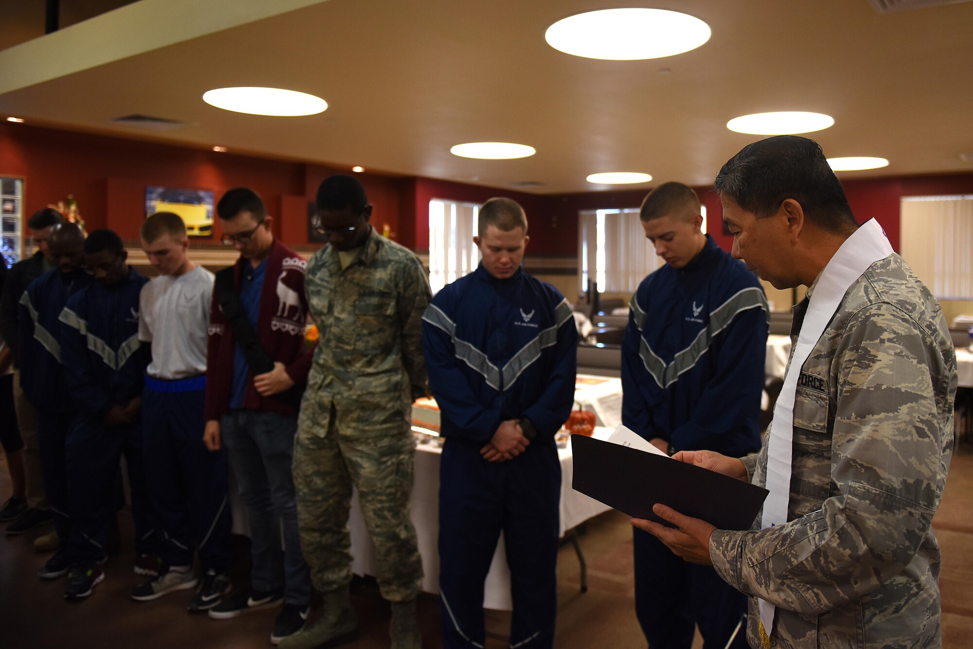 U.S. Air Force Chaplain (Capt.) Antonio Rigonan, 17th Training Wing, provides an opening prayer for Thanksgiving at the Cressman Dining Facility on Goodfellow Air Force Base, Texas, Nov. 24, 2016. Base leadership took turns serving service members, retirees and dependents for Thanksgiving. (U.S. Air Force photo by Airman 1st Class Caelynn Ferguson/Released)