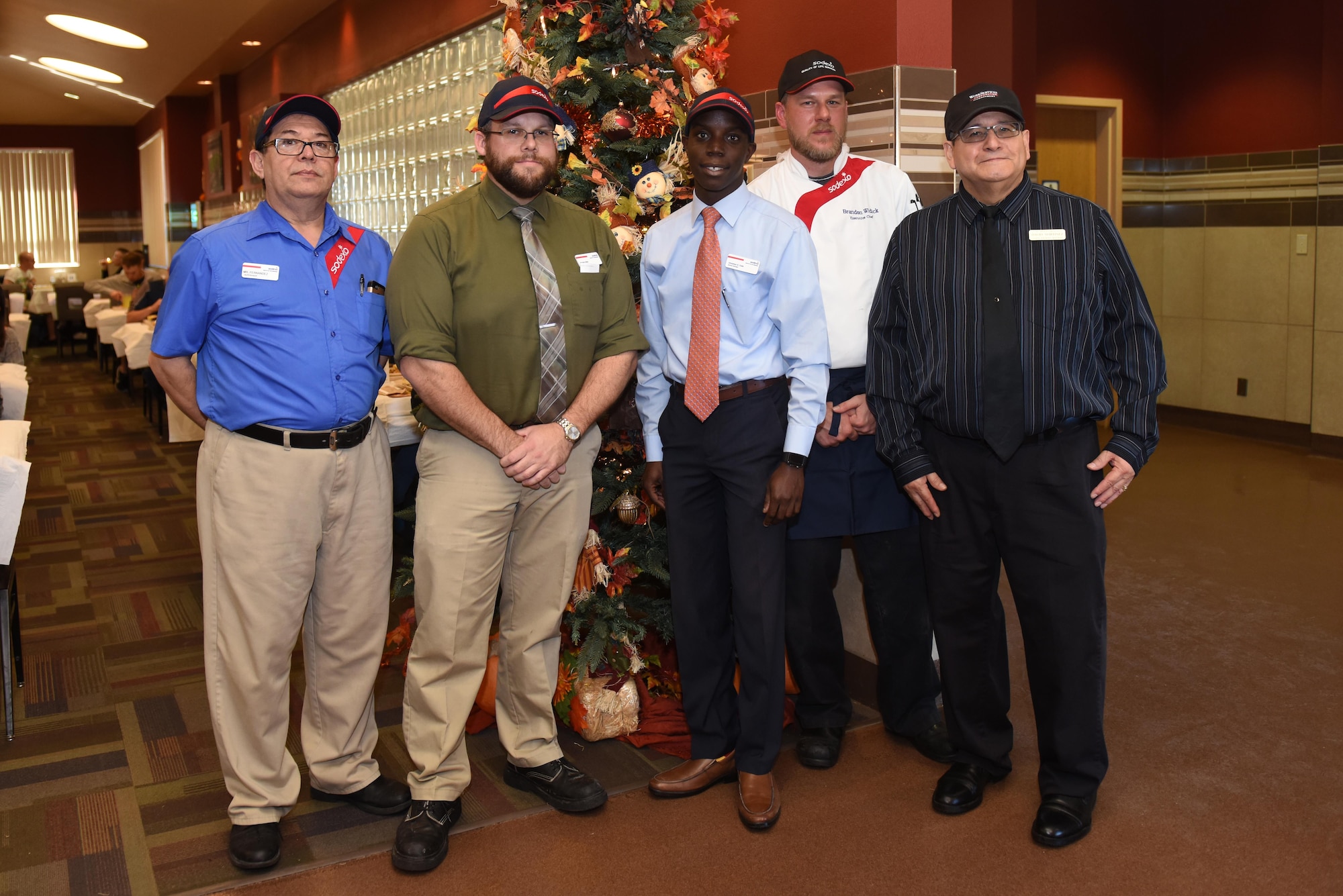 Cressman Dining Facility management pose for a photo at the Cressman Dining Facility on Goodfellow Air Force Base, Texas, Nov. 24, 2016. The employees spent part of their day serving Thanksgiving meals to Goodfellow service members. (U.S. Air Force photo by Airman 1st Class Caelynn Ferguson/Released)