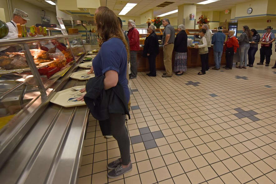 Red Cross staff members and volunteers wait in line at the dining facility at Seymour Johnson Air Force Base, North Carolina, Nov. 24, 2016. Since Hurricane Matthew, the Red Cross has sent 111 emergency response vehicles to deliver relief to hard-hit areas, distributed nearly 15,000 clean-up kits and more than 4,600 comfort kits. (U.S. Air Force photo by Airman 1st Class Ashley Williamson)