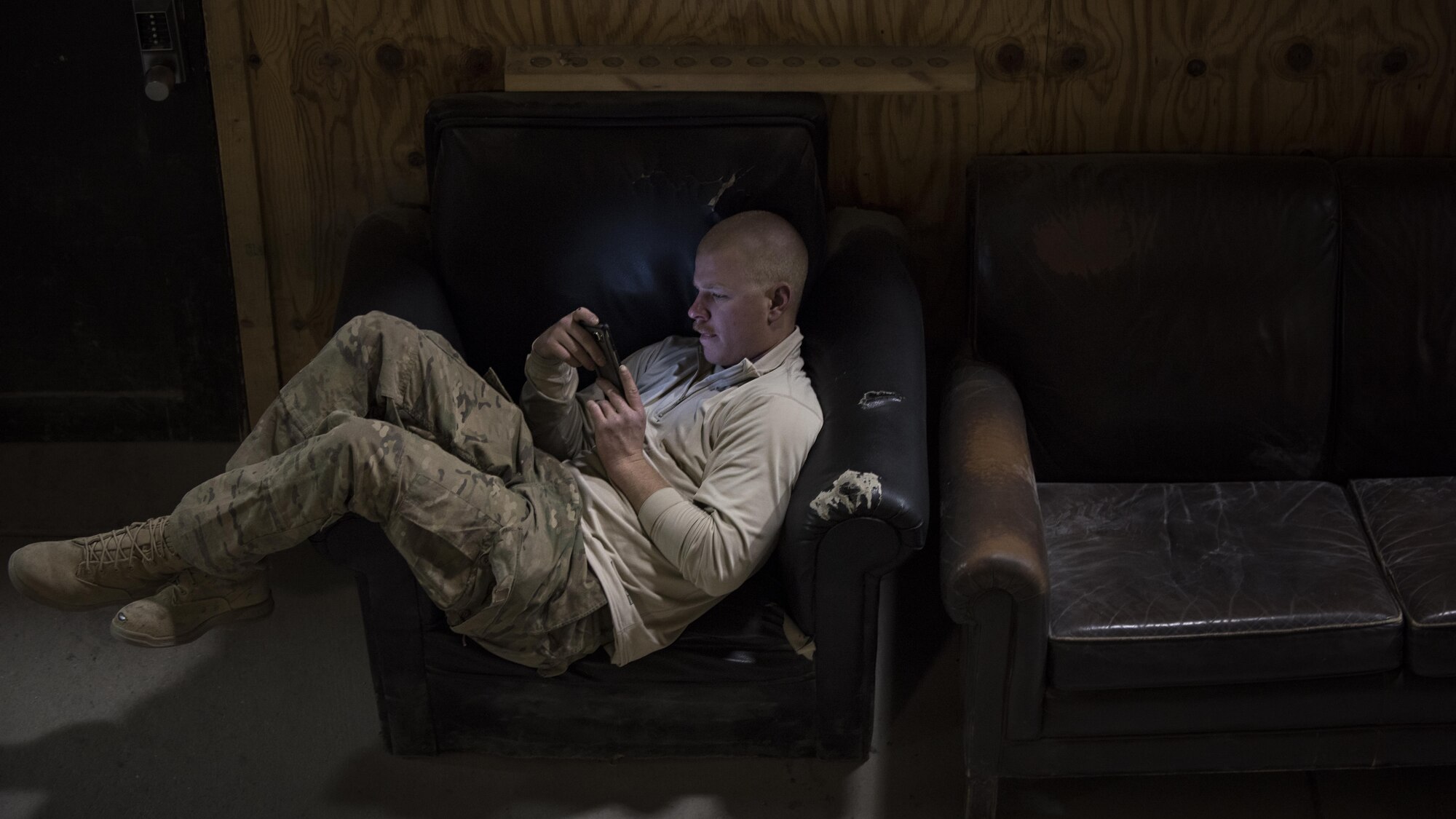 Staff Sgt. Ethan Chambers, 455th Expeditionary Civil Engineer Squadron pavements and equipment, scrolls through social media on Thanksgiving, Nov. 24, 2016 at Bagram Airfield, Afghanistan. Many service members use social media to keep in touch with family and friends while deployed, especially during the holidays. (U.S. Air Force photo by Staff Sgt. Katherine Spessa)